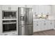 Well-equipped kitchen with stainless steel refrigerator, microwave, and modern cabinetry at 367 W Amber Oak Dr # 53, Selma, NC 27576