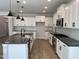 Modern kitchen with white cabinets, stainless steel appliances, and granite countertops at 367 W Amber Oak Dr # 53, Selma, NC 27576