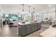 Open concept kitchen with gray island, stainless steel appliances, and seamless living space at 367 W Amber Oak Dr # 53, Selma, NC 27576