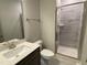 Bathroom features a modern shower with glass door, dark vanity, and tiled floors at 399 W Amber Oak Dr # 52, Selma, NC 27576