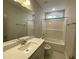 Bathroom with a modern vanity, large mirror, and a shower-tub combo, providing functionality and style at 399 W Amber Oak Dr # 52, Selma, NC 27576
