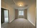Bedroom with neutral carpet features a window and walk-in closet, ready for personalization at 399 W Amber Oak Dr # 52, Selma, NC 27576