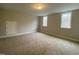Neutral bedroom with carpet, dual windows and access door at 399 W Amber Oak Dr # 52, Selma, NC 27576