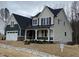 Charming two-story home showcasing a covered front porch, an attached two-car garage, and well-maintained landscaping at 399 W Amber Oak Dr # 52, Selma, NC 27576