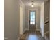 Welcoming hallway with a stylish front door, globe lighting, and wood-look flooring at 399 W Amber Oak Dr # 52, Selma, NC 27576
