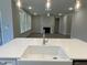 Modern kitchen features a white farmhouse sink and opens to the living room with a fireplace at 399 W Amber Oak Dr # 52, Selma, NC 27576