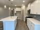 Bright kitchen with a large island, pendant lights, stainless steel appliances, and gray subway tile backsplash at 399 W Amber Oak Dr # 52, Selma, NC 27576