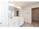 Bright bathroom featuring double sink vanity with marble countertops, large mirror, and walk in closet at 135 Newport Lndg, Garner, NC 27529