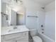 Well-lit bathroom features a shower-tub combo, modern fixtures, and bright white vanity at 135 Newport Lndg, Garner, NC 27529