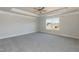 Bright bedroom featuring a ceiling fan, neutral walls, gray carpet, and a window at 135 Newport Lndg, Garner, NC 27529