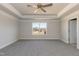 Spacious bedroom featuring a ceiling fan, neutral walls, gray carpet, and a window at 135 Newport Lndg, Garner, NC 27529