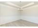Dining room with wainscoting, hardwood floors, a modern chandelier, and natural light at 135 Newport Lndg, Garner, NC 27529
