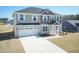 Beautifully landscaped two-story home with a spacious driveway and attached two-car garage at 135 Newport Lndg, Garner, NC 27529