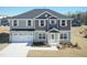 Two-story home with a two-car garage and beautifully landscaped front yard at 135 Newport Lndg, Garner, NC 27529