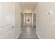 Bright hallway featuring hardwood floors and neutral paint, leading to various rooms at 135 Newport Lndg, Garner, NC 27529