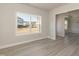 Living room showcasing hardwood floors, natural light, and open access to other areas at 135 Newport Lndg, Garner, NC 27529
