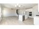 Bright open-concept living space featuring modern kitchen, dining, and staircase at 135 Newport Lndg, Garner, NC 27529