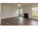 Spacious living room with hardwood floors, fireplace, and large windows at 135 Newport Lndg, Garner, NC 27529