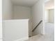 Staircase with carpeted steps and white walls leading to a hallway, creating an open feel at 135 Newport Lndg, Garner, NC 27529