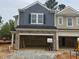 New two-story townhouse showcasing stone accents, siding, and open garage space in a residential neighborhood at 136 Malbec Dr, Chapel Hill, NC 27516