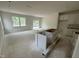 Spacious living room with ample natural light, bare concrete floors, and rough in for kitchen appliances at 136 Malbec Dr, Chapel Hill, NC 27516