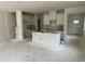 Spacious living room with ample natural light, bare concrete floors, and rough in for kitchen appliances at 136 Malbec Dr, Chapel Hill, NC 27516