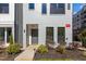 Modern townhome exterior with gray brick and landscaping at 700 W North St # 101, Raleigh, NC 27603