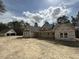 New construction home with a two car garage set among tall green trees and open sky in a rural area at 1275 Cameron Hill Rd, Cameron, NC 28326