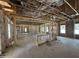 Unfinished living room shows framing and insulation and an exposed ceiling with temporary support structures at 1275 Cameron Hill Rd, Cameron, NC 28326