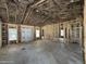 Unfinished living room shows framing and insulation, windows for natural light, and high, vaulted ceilings at 1275 Cameron Hill Rd, Cameron, NC 28326