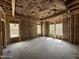 Unfinished bedroom shows framing and insulation, several windows for natural light, and an exposed ceiling at 1275 Cameron Hill Rd, Cameron, NC 28326