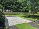 Spacious backyard with a stone patio, lush green grass, and a wood fence, perfect for outdoor entertaining and relaxation at 14020 Durant Rd, Raleigh, NC 27614