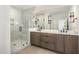 Modern bathroom featuring a glass shower and double vanity at 14020 Durant Rd, Raleigh, NC 27614