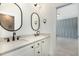 Modern bathroom features double sinks with black fixtures at 14020 Durant Rd, Raleigh, NC 27614