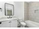 Modern bathroom with a sleek vanity, bathtub, and stylish tile at 14020 Durant Rd, Raleigh, NC 27614