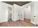 Bedroom with custom ceiling, hardwood floors, and double doors leading to an adjacent room at 14020 Durant Rd, Raleigh, NC 27614