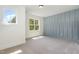 Bedroom with bright blue wall and light coming in from two windows at 14020 Durant Rd, Raleigh, NC 27614