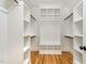 Walk-in closet with custom shelving and wood flooring at 14020 Durant Rd, Raleigh, NC 27614