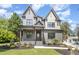 Beautiful two-story home featuring dual gables, gray brick, a covered porch, and professional landscaping at 14020 Durant Rd, Raleigh, NC 27614