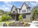 Charming home with manicured lawn and landscaping featuring a covered front porch and a brick and siding facade at 14020 Durant Rd, Raleigh, NC 27614