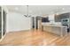 Bright, open-concept kitchen and dining area features hardwood floors and modern dark cabinetry at 14020 Durant Rd, Raleigh, NC 27614
