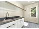 Laundry room with black countertop and a window at 14020 Durant Rd, Raleigh, NC 27614