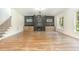Bright living room with hardwood floors, fireplace with built-ins, modern lighting, and a staircase at 14020 Durant Rd, Raleigh, NC 27614