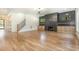 Bright living room featuring hardwood floors, a modern fireplace with built-ins, and a staircase at 14020 Durant Rd, Raleigh, NC 27614