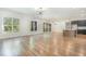 Open living space featuring hardwood floors, modern lighting, large windows, and a kitchen island at 14020 Durant Rd, Raleigh, NC 27614