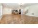 Open living space showcasing hardwood floors, modern lighting, and a kitchen island with barstool seating at 14020 Durant Rd, Raleigh, NC 27614