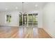 Bright and airy living space with hardwood floors, modern lighting, and sliding glass doors to a porch at 14020 Durant Rd, Raleigh, NC 27614