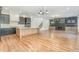 Open living space featuring hardwood floors, a modern kitchen, fireplace, and staircase at 14020 Durant Rd, Raleigh, NC 27614