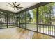 This is an outdoor screened-in porch with wooden floors and ceiling fan perfect for relaxing outdoors at 14020 Durant Rd, Raleigh, NC 27614