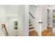 Staircase with wooden handrail and natural light at 14020 Durant Rd, Raleigh, NC 27614